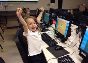 Elementary Gallery student holding her arms up