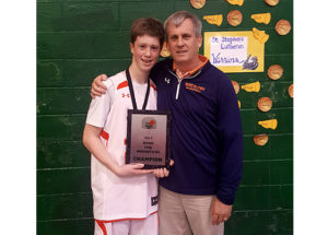RLS basketball player and coach smiling with plaque