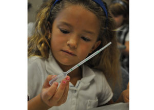 Elementary Gallery student holding a pipette