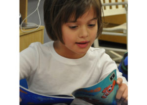 Elementary Gallery student reading a book